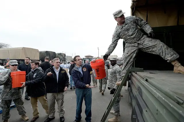 Governor Cuomo unloads food and supplies with National Guard at Long Beach Distribution Center.